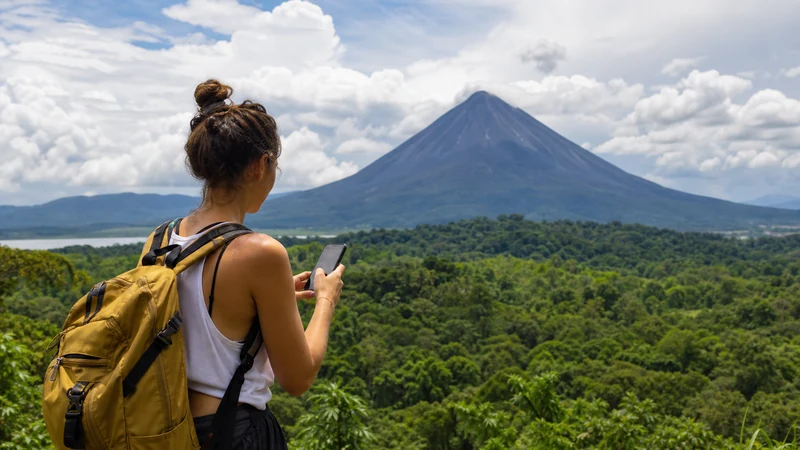 Traveller using a smartphone in Costa Rica for what to expect from mobile data in la fortuna