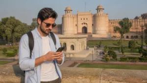 Traveller using a smartphone near Lahore Fort