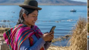 Traveller using a smartphone in Bolivia while researching mobile internet around lake titicaca in bolivia