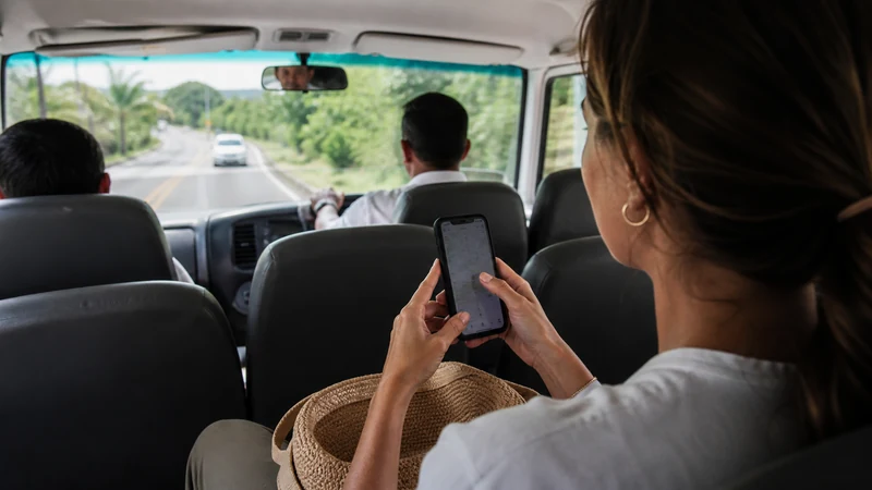 Traveller using a smartphone in Costa Rica for getting mobile data from liberia airport to tamarindo