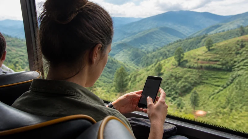 Traveller selecting a mobile network during a bus journey in Rwanda