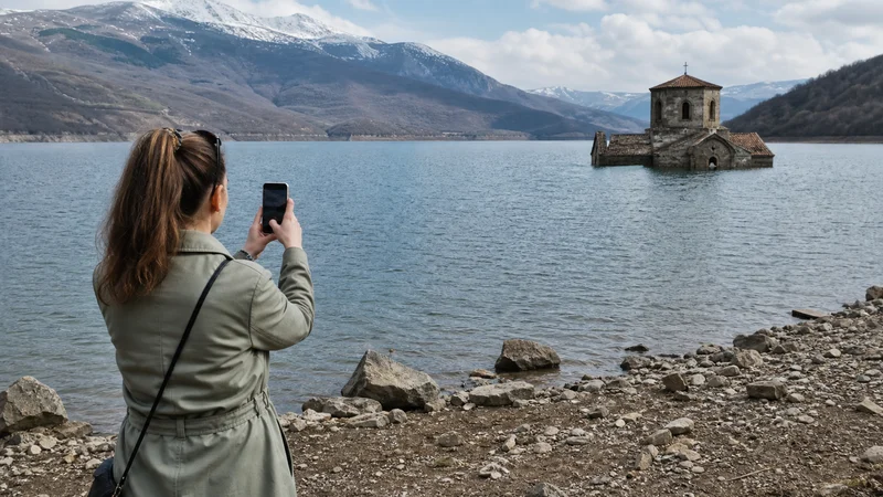 Traveller using a smartphone during mobile internet for visiting mavrovo national park in North Macedonia.