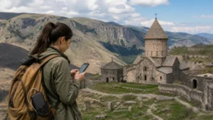 Traveller navigating with a smartphone beside an Armenian monastery