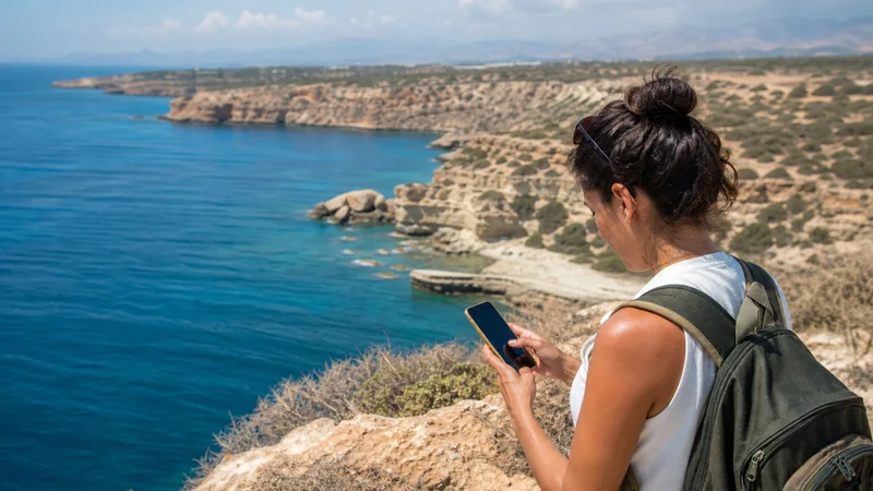 Traveller checking mobile data on the Cyprus coast