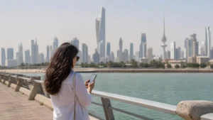 Traveller using a smartphone in a Kuwait setting related to how to stay online while travelling in kuwait