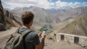 Traveller using mobile navigation in the Tajik mountains