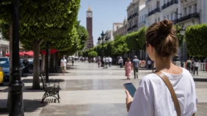 Traveller using phone navigation near Avenue Habib Bourguiba in Tunis