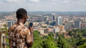 Uganda town skyline with a traveller using a phone.
