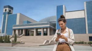 Traveller checking a smartphone outside a Nukus museum