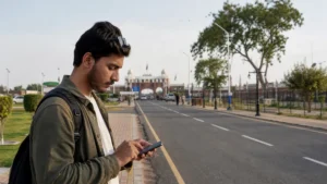 Traveller preparing mobile data for a Pakistan–India land journey