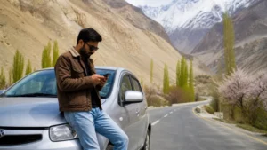 Traveller checking mobile data beside a car on a Pakistan road trip