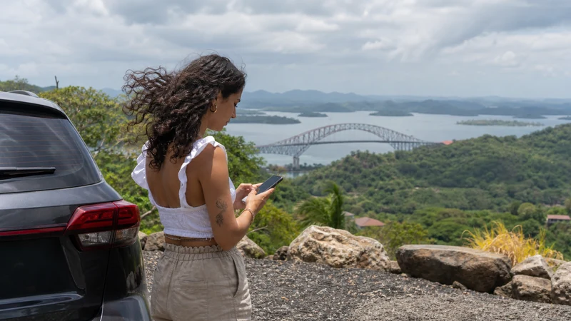 Traveller using a smartphone in Panama for panama esim for rental car