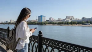 Tourist using a smartphone on the Irtysh River embankment in Pavlodar.