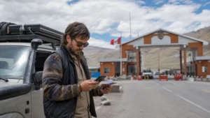 Traveller using a smartphone in Peru for peru bolivia border mobile internet