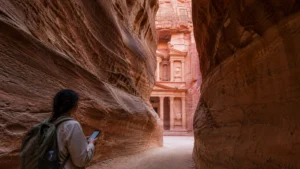 Traveller using a smartphone in Jordan for mobile internet in petra: esim, wi-fi and tourist data guide
