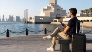 Traveller using a smartphone in Qatar for qatar esim for a doha stopover: wi-fi, sim and esim guide