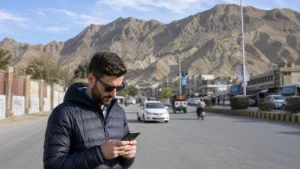 Traveller using mobile data on a Quetta city street