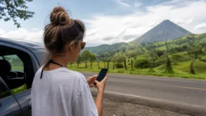 Traveller using a smartphone in Costa Rica for staying online from san josé to la fortuna