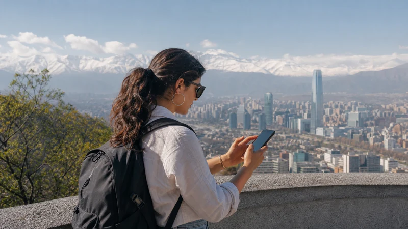 Traveller using a smartphone in Chile for staying online from santiago to valparaíso