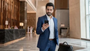 Business traveller checking dual-SIM settings in a Riyadh hotel.