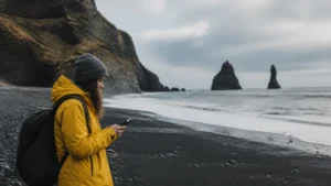 Traveller using a smartphone in Iceland’s South Coast