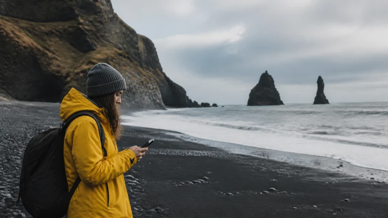 Traveller using a smartphone in Iceland’s South Coast