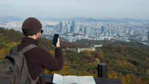 Traveller checking mobile coverage from a Seoul viewpoint