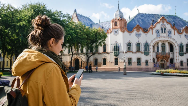 Traveller using a smartphone during mobile internet in subotica in Serbia.