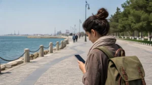 Traveller using mobile internet along the Sumqayit waterfront