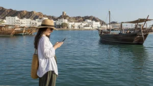 Traveller using a smartphone during visitor on Sur waterfront