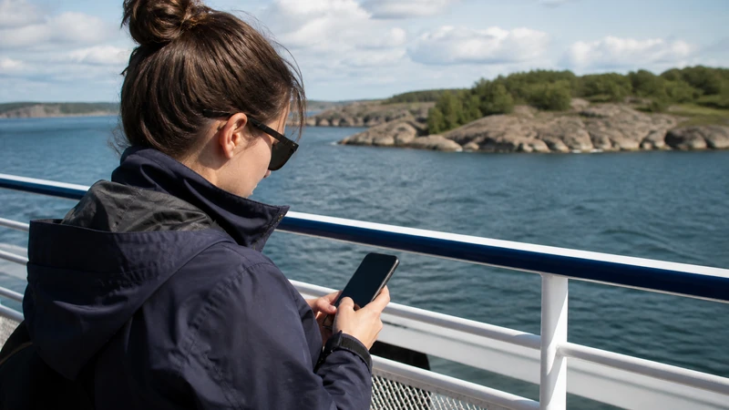 Traveller using a smartphone while preparing for mobile internet on sweden’s archipelago ferries
