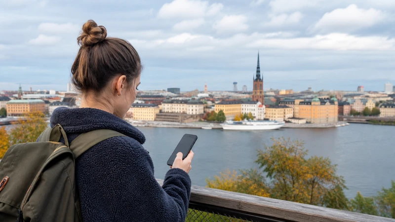 Traveller using a smartphone while preparing for sweden esim coverage: cities, roads and rural areas