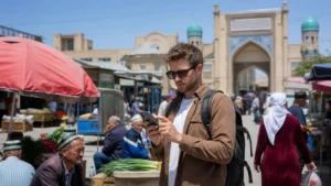 Traveller configuring an Android phone near Panjshanbe Bazaar