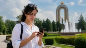 Traveller configuring an iPhone in a Dushanbe park