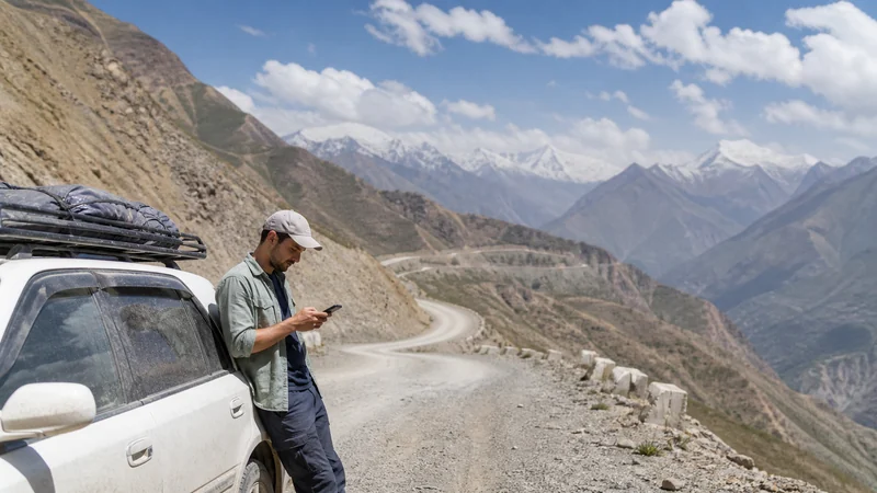 Traveller using a smartphone for tajikistan road trip mobile internet: esim and offline maps