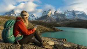 Traveller using a smartphone in Chile for staying online around torres del paine
