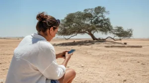 Traveller using a smartphone in Bahrain for tree of life bahrain mobile internet