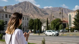 Traveller using a smartphone for mobile internet in tursunzoda: esim and tourist connectivity
