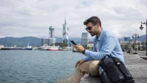 Traveller using a smartphone on the Batumi waterfront