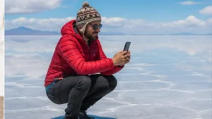 Traveller using a smartphone in Bolivia while researching mobile internet in uyuni and around the salt flats