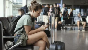 Traveller using a smartphone inside Charleroi Airport in Belgium
