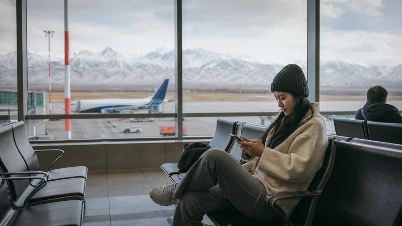 Traveller using a smartphone in Kyrgyzstan for wifi manas airport