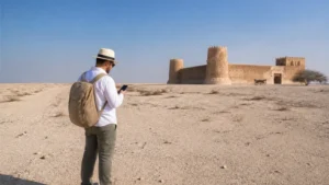 Traveller using a smartphone in open desert