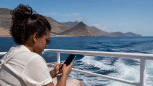 Traveller using mobile data aboard a Cape Verde ferry