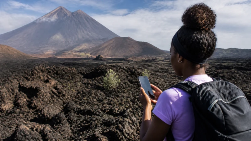 Traveller using mobile internet on Fogo Island, Cape Verde