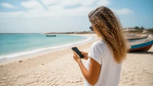 Traveller using mobile internet on Maio Island, Cape Verde