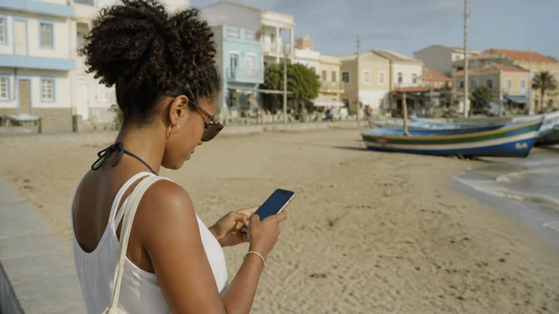 Traveller using mobile data in Sal Rei, Cape Verde