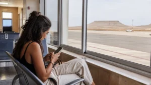 Traveller using WiFi at Boa Vista Airport in Cape Verde