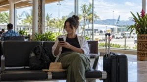 Traveller using a smartphone in the Nadi Airport waiting area